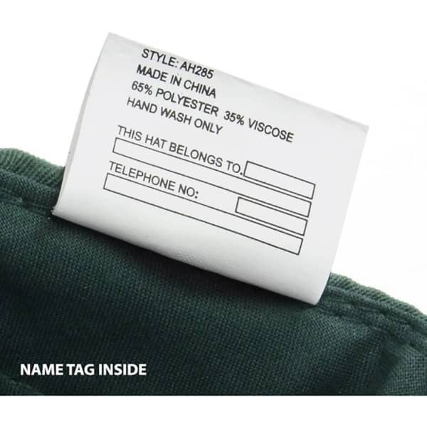 A green cap with a label featuring washing instructions and space for a name tag.
