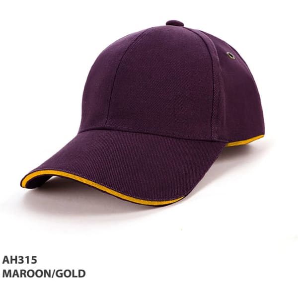 A maroon cap with gold piping, featuring a logo and a curved brim.