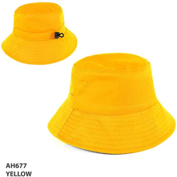 A yellow bucket hat with a wide brim and an adjustable cord. It features a logo on the side.