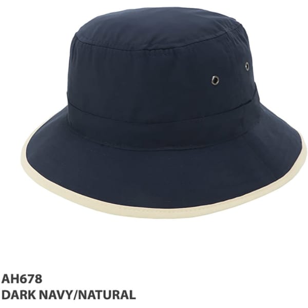 A dark navy bucket hat with a natural trim and ventilation eyelets, featuring a logo.