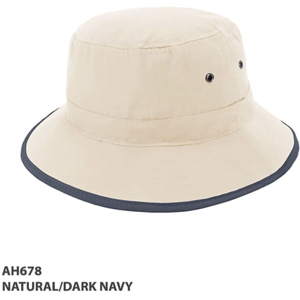 A beige microfibre bucket hat with a dark navy brim, featuring ventilation eyelets and a logo.
