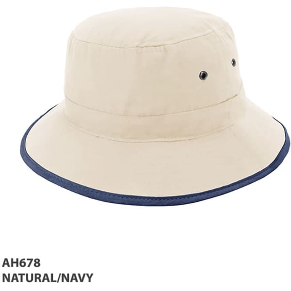A natural and navy microfibre bucket trim hat featuring ventilation eyelets and a stitched brim.