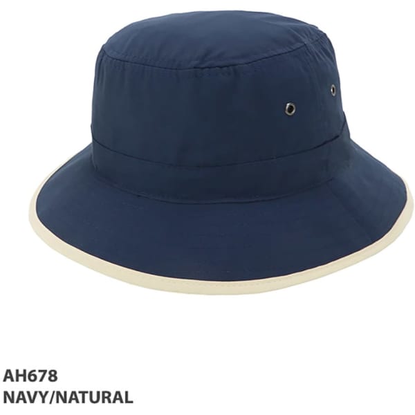 A navy and natural microfibre bucket trim hat featuring ventilation eyelets and a wide brim. Includes branding.