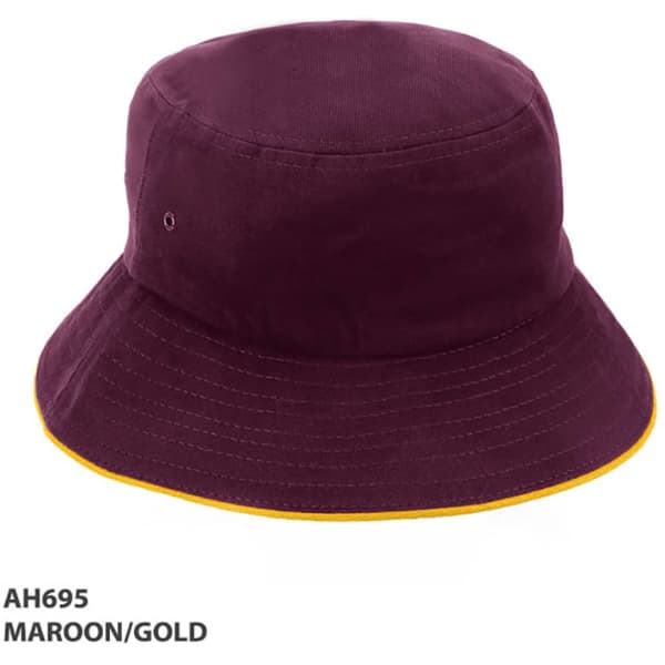 A maroon bucket hat with a gold trim and a logo on the side.