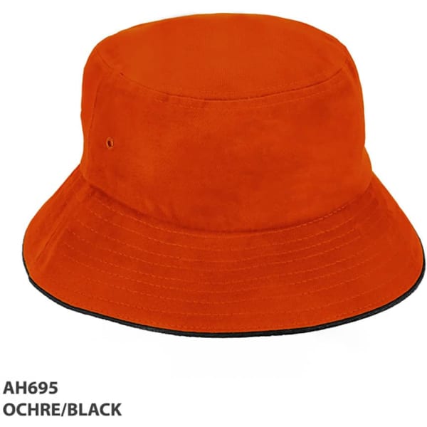 An ochre and black HBC Sandwich Bucket Hat with a wide brim and a logo.