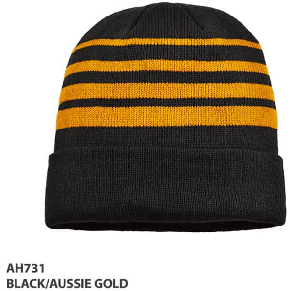 A knitted beanie in black and aussie gold with horizontal stripes and a folded brim. It features a logo.