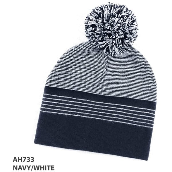 A navy and white striped beanie with a pom-pom on top and a logo.