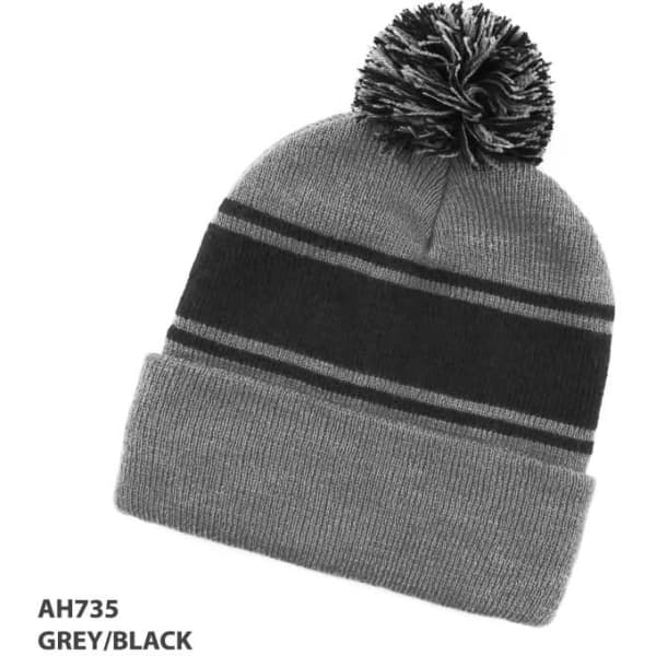 A grey and black beanie with a striped design and a pom-pom on top. Features a logo.
