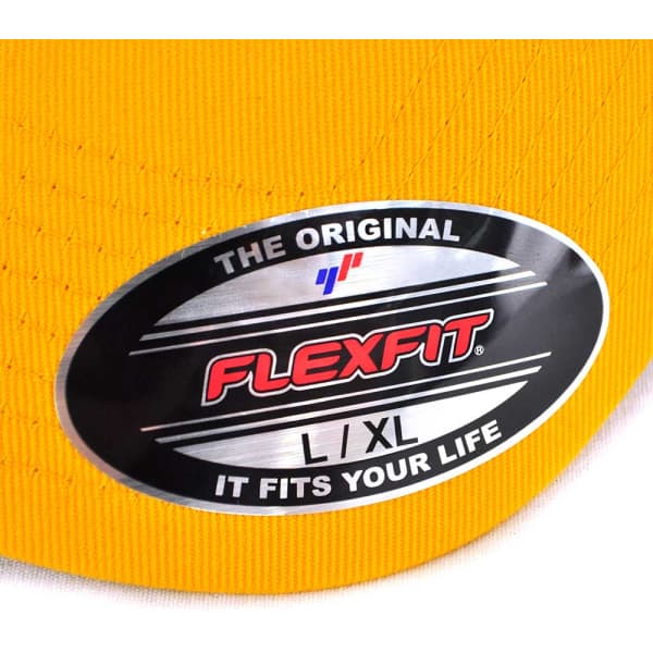 A yellow cap with a black oval label featuring branding, indicating size L/XL.
