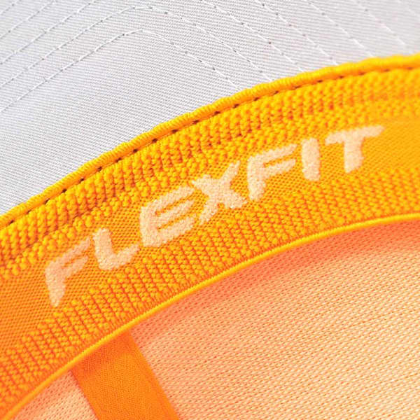 A close-up of a white and orange cap featuring a branding logo. The fabric shows textured detailing.