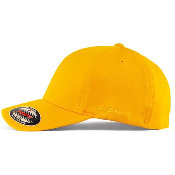 A yellow FLEXFIT cap with a curved peak and a logo on the side. The design features a fitted style.