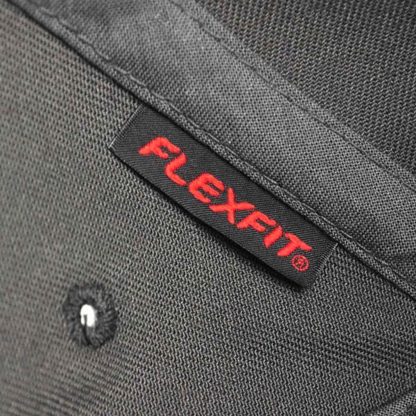 A black cap with a textured surface featuring a label with the brand name Flexfit.