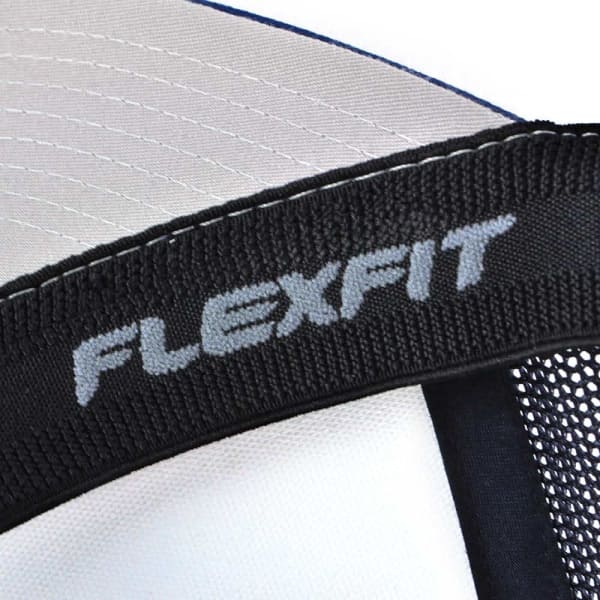A close-up of a black trucker cap featuring a grey branded logo and a structured mesh design.