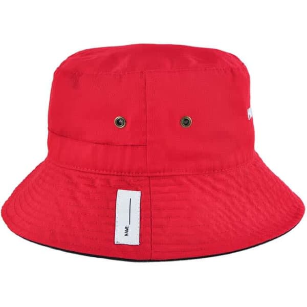 A red reversible bucket hat with an adjustable toggle and a logo, featuring ventilation holes.