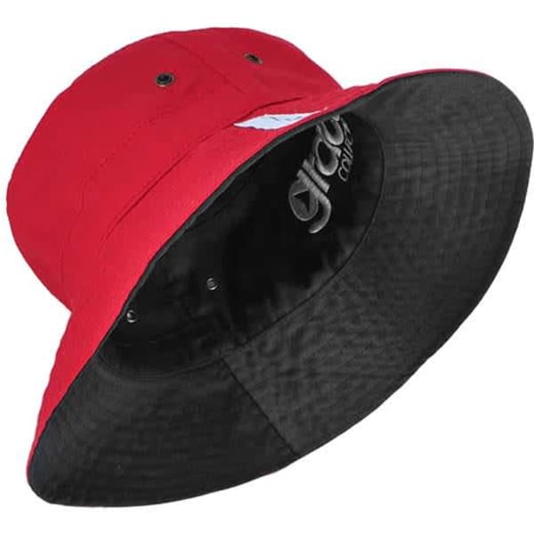 A reversible bucket hat in bright red with a black interior and adjustable toggle. It features a logo on the inside.