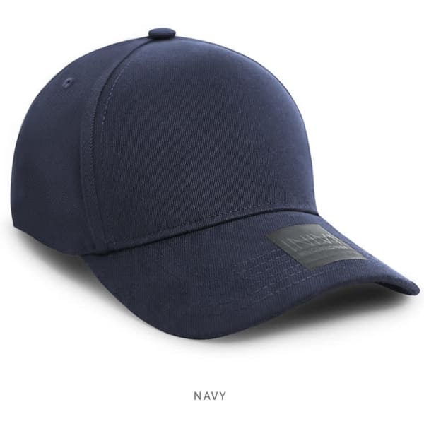 A navy cap featuring a branded label. It has a classic design and a structured shape.