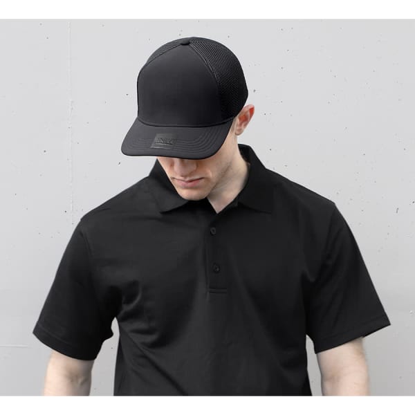 A black polyester/mesh cap with a logo, worn by a person in a matching black polo shirt.