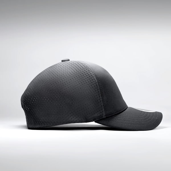 A black premium nylon cap featuring perforated detailing and a curved peak, with a logo on the side.
