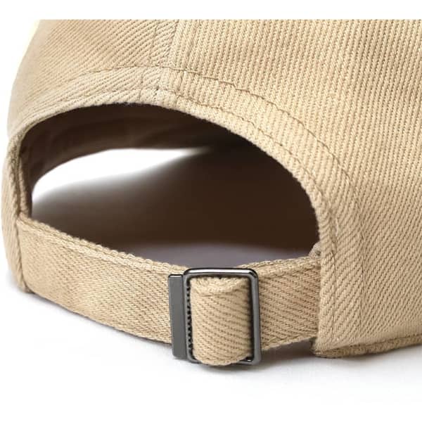 A beige cap with a buckle fastening, showcasing a textured fabric and a curved brim.