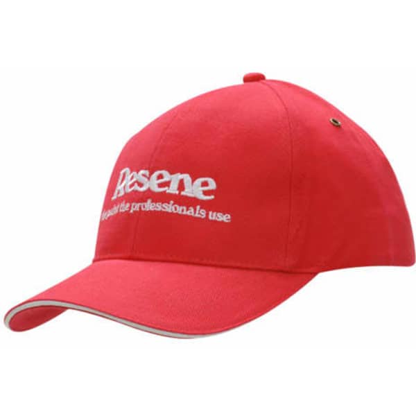 A red cap featuring a white embroidered logo and a contrasting sandwich trim. Includes brass eyelets for ventilation.