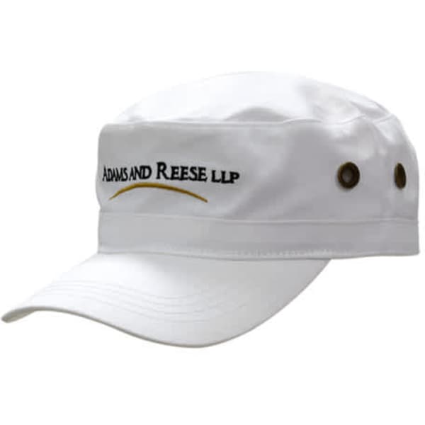 A white military style cap with a peak, featuring a logo and brass buttons on the sides.