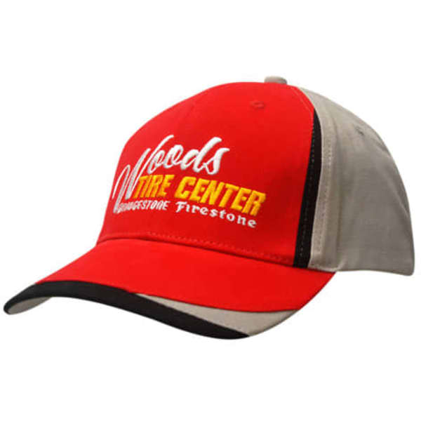 A red and grey cap with fabric inserts on the crown and peak. It features a logo on the front.