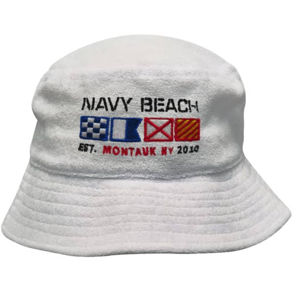 A white terry towelling bucket hat featuring a nautical design and logo, with colourful flag symbols.