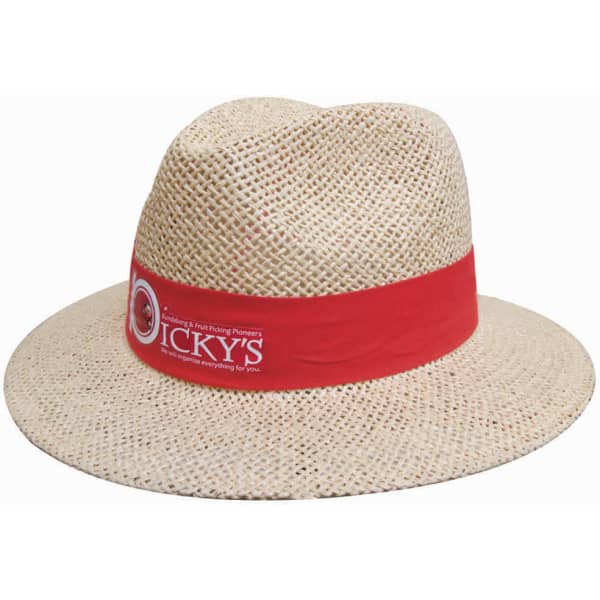 A straw hat with a wide brim, featuring a red band and a logo. The hat has a natural beige colour.
