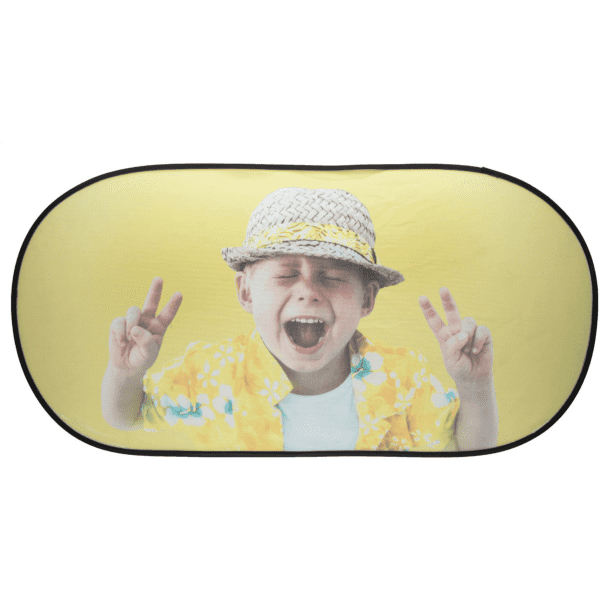 A folding car sunshade featuring a cheerful child in a yellow floral shirt and hat, with a playful peace sign gesture.