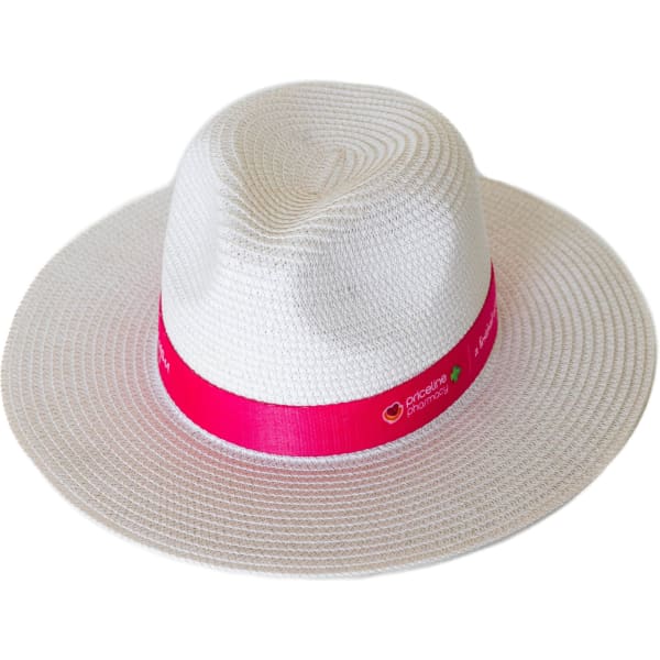 A white Fedora paper straw hat with a pink ribbon band, featuring a logo.