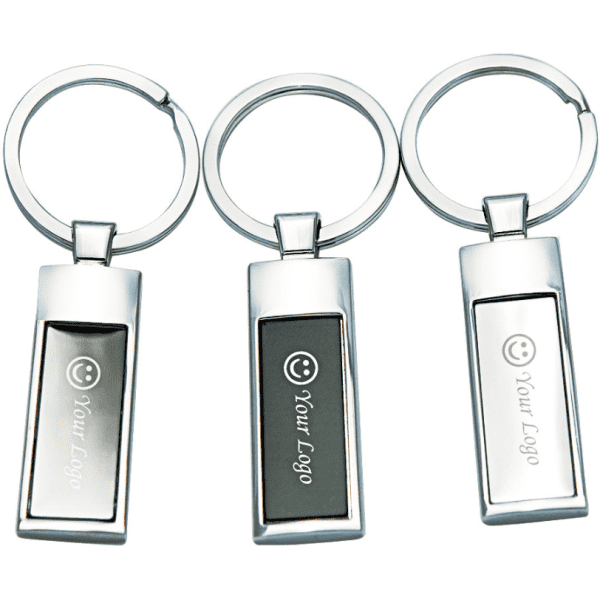 A set of three silver keyrings, featuring rectangular designs and a smooth finish, with branding on each.