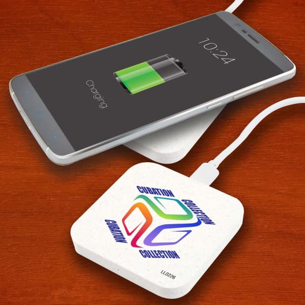 A wireless charger with a colourful logo, featuring a textured surface, next to a smartphone displaying a charging battery icon.