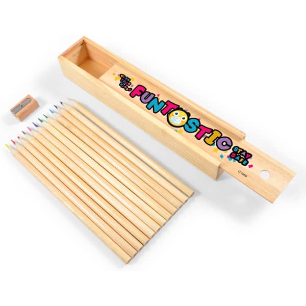 A wooden pencil box containing coloured pencils in various shades and a pencil sharpener. The box features a playful logo.
