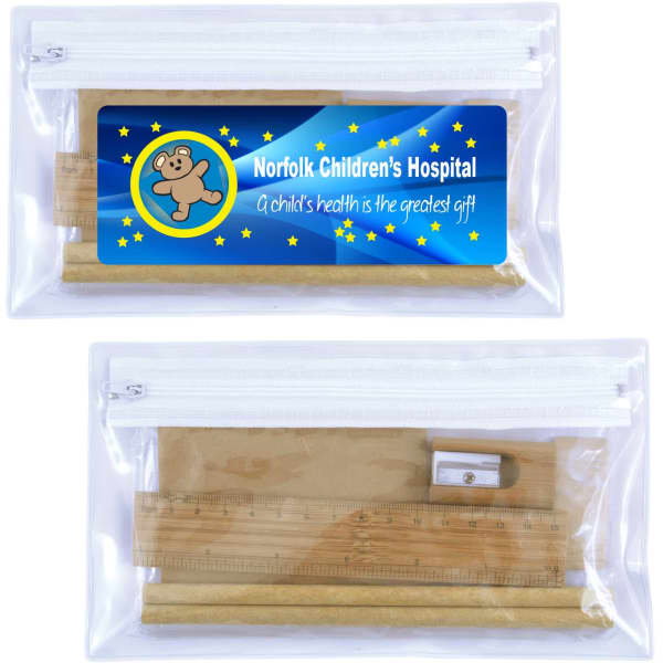 A clear zip pouch containing a ruler, sharpener, and pencil, with a colourful branding label attached.