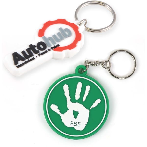 Two keytags, one white with a logo and the other green featuring a handprint design, both attached to keyrings.