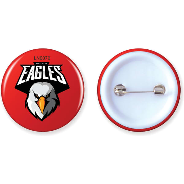 A red button badge featuring an eagle design and a metal pin on the back.