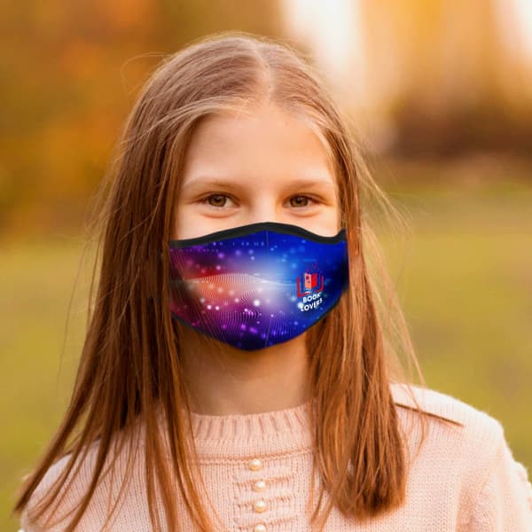 A blue children's face mask features a vibrant, colourful design, displayed on a young girl in an outdoor setting.