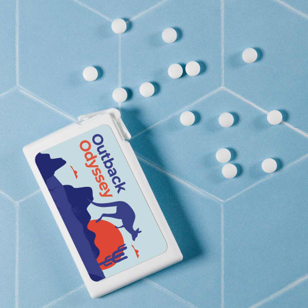 A rectangular container of sugar-free breath mints in white, with white mints scattered on a light blue background.