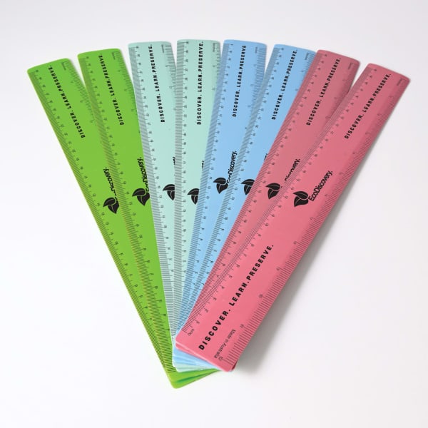 A set of 30cm recycled plastic rulers in green, blue, pink, and other colours with a brand logo.