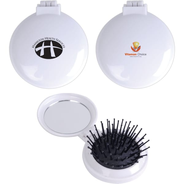 A compact pop-up brush and mirror set in white featuring a logo, with a bristle brush on one side and a mirror inside.