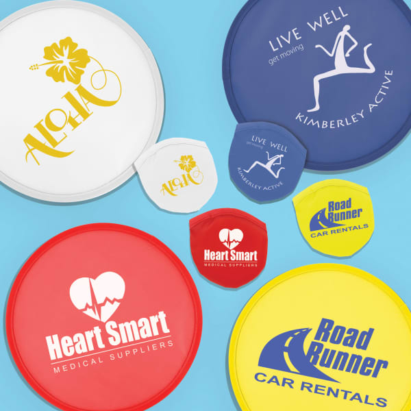 A variety of colourful frisbees in red, blue, yellow, and white, featuring different logos and designs.