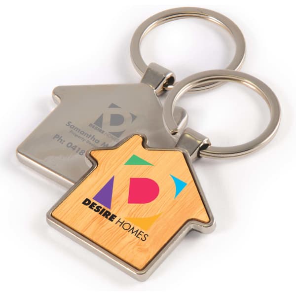 A house-shaped keytag featuring a bamboo and metal design, with a logo on one side.