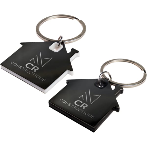 Two house-shaped keytags in black and white, each featuring a logo and a metal keyring attachment.