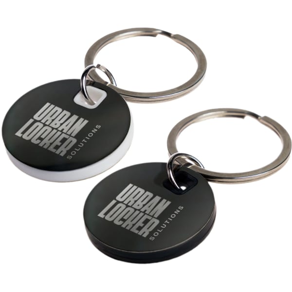A circle stainless steel keytag in black and white, featuring a branding logo, attached to a metal keyring.