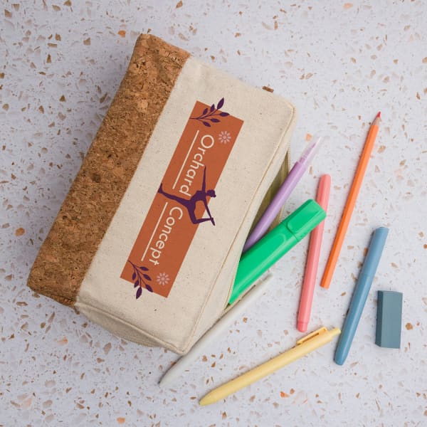 A utility case in cream with a cork top, accompanied by various coloured pens and an eraser.