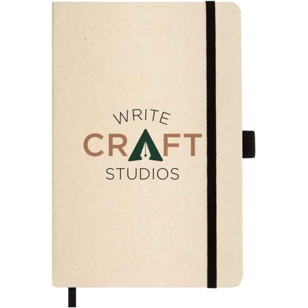 A beige A5 notebook with a black elastic band and a logo centred on the cover.