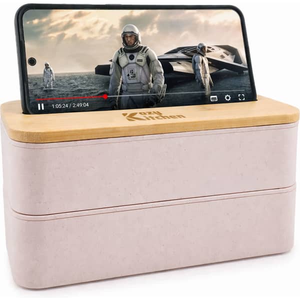 A pale pink eco lunch box with a bamboo lid that holds a smartphone, featuring a logo on the front.