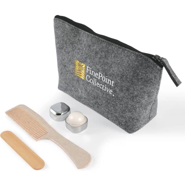 A grey cosmetic pack with a zipper, containing a comb, two containers, and a wooden spatula. It has a logo.