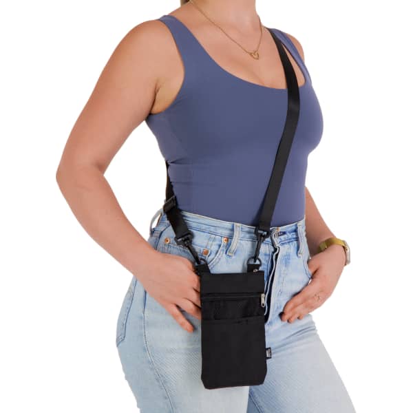 A black neck pouch is worn crossbody, featuring multiple pockets and an adjustable strap.