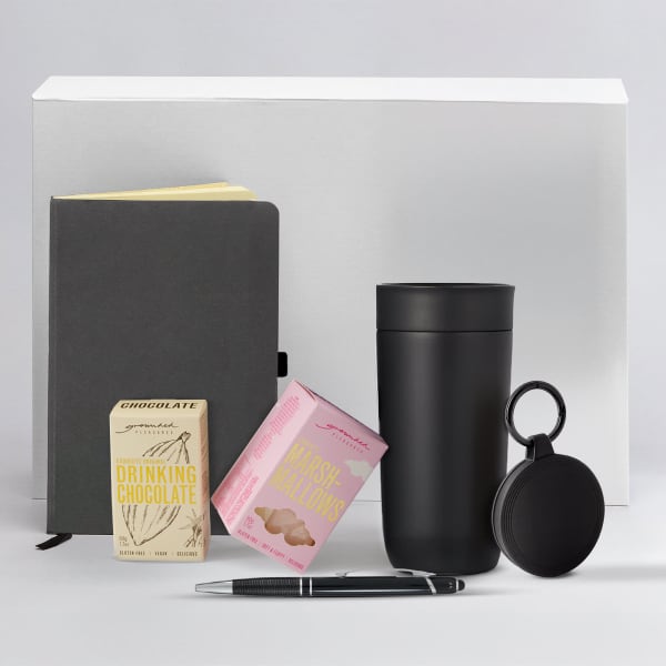 A drink bottle, a notebook, a pen, a chocolate box, and a cookie box, all in shades of black and muted tones.
